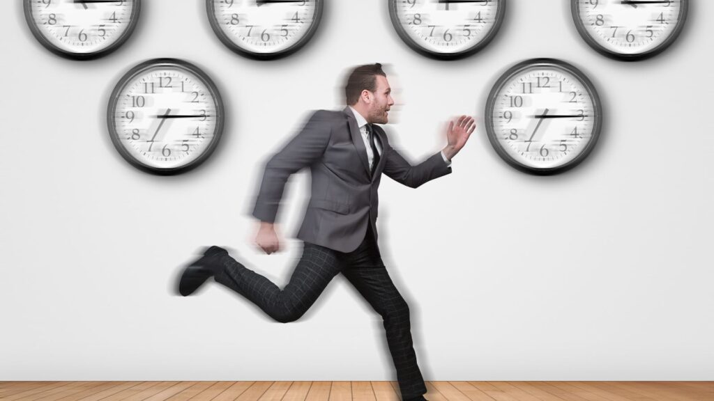 Time management concept illustrated using a man running after time