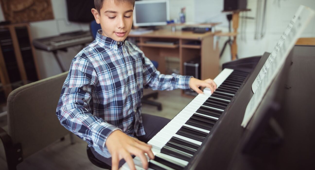 A boy practicing on the piano- does practice make perfect?