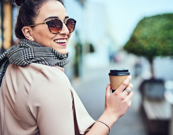 The best strokes of life- A happy girl holding a cup of coffee
