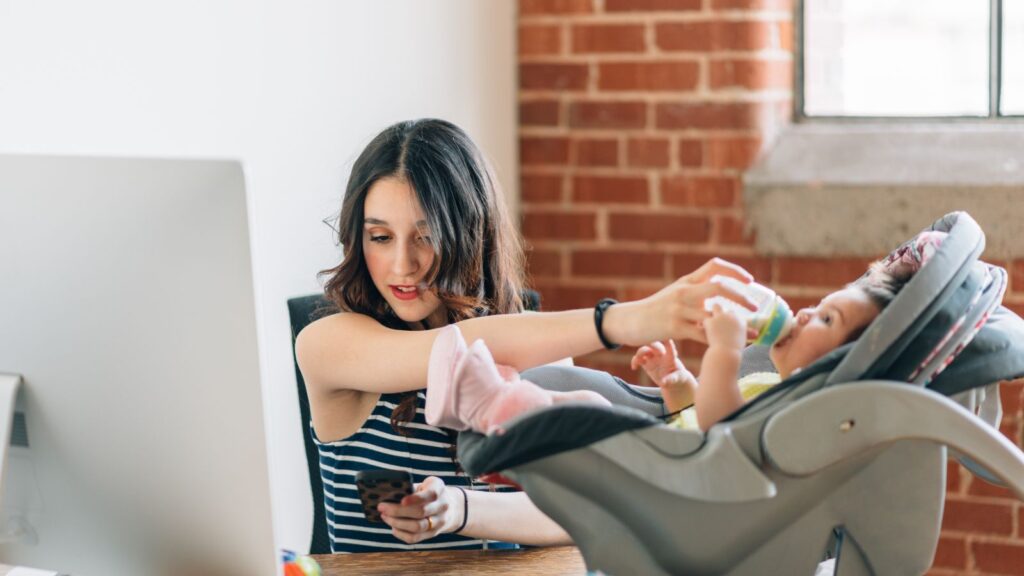 Business mum feeding her baby while working at home | strategies for work-life balance for entrepreneurs